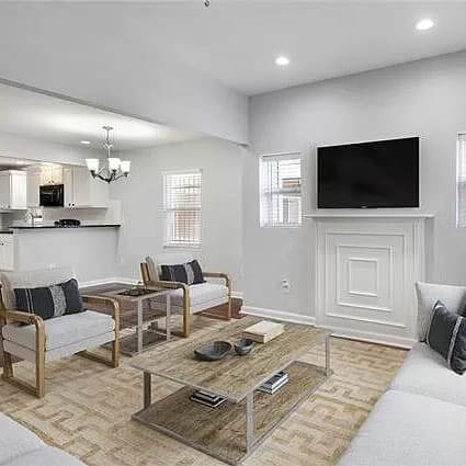 A contemporary living room with white walls and modern furniture