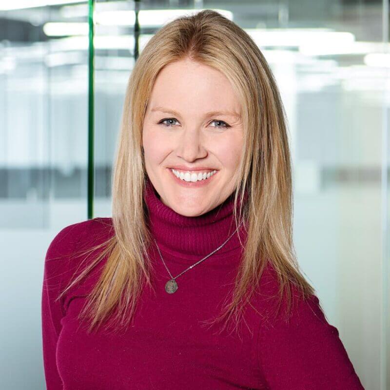 Portrait of a blonde woman in a burgundy turtleneck