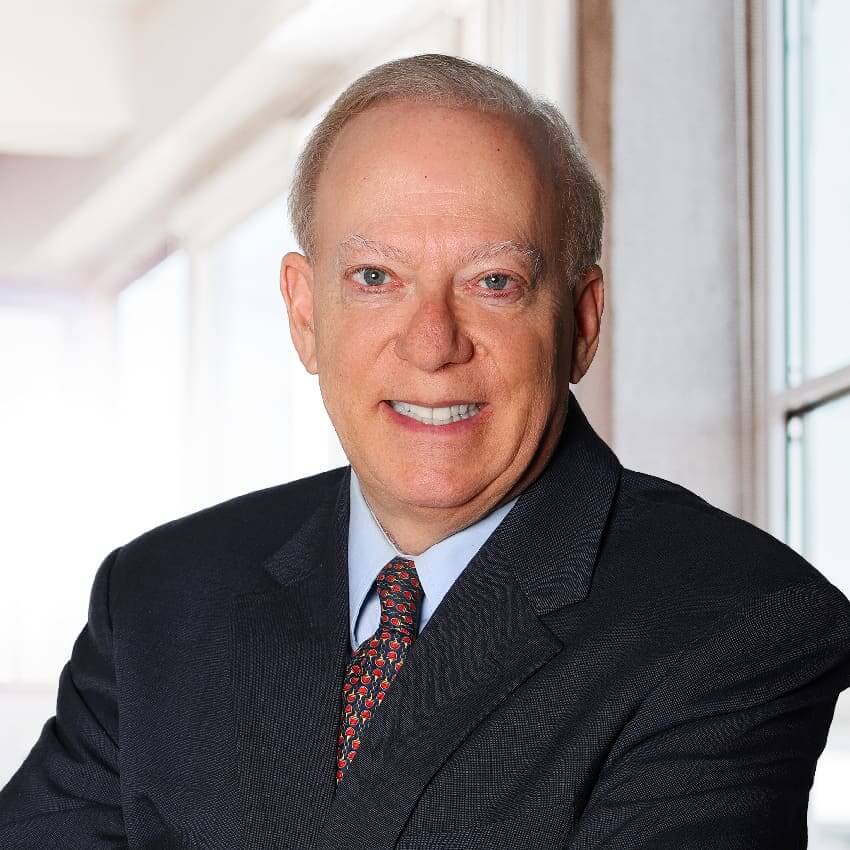 Portrait of an executive man wearing a dark coat and burgundy tie