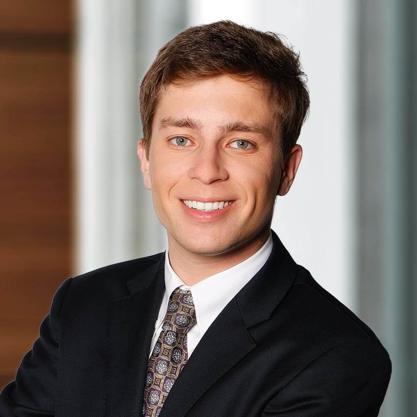 Young man wearing a dark coat and charcoal tie