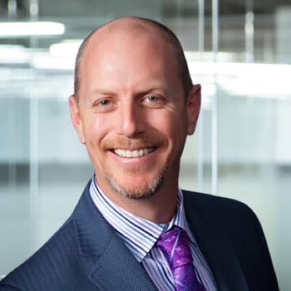 portrait of a smiling executive in a purple tie